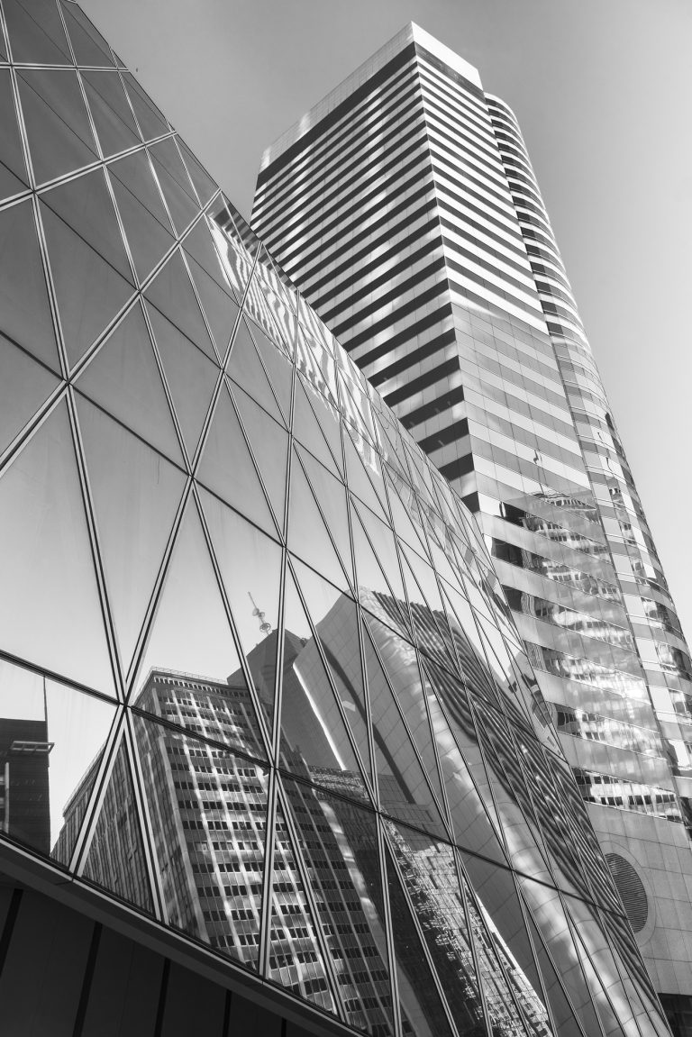 Reflection of urban skyline on modern office building